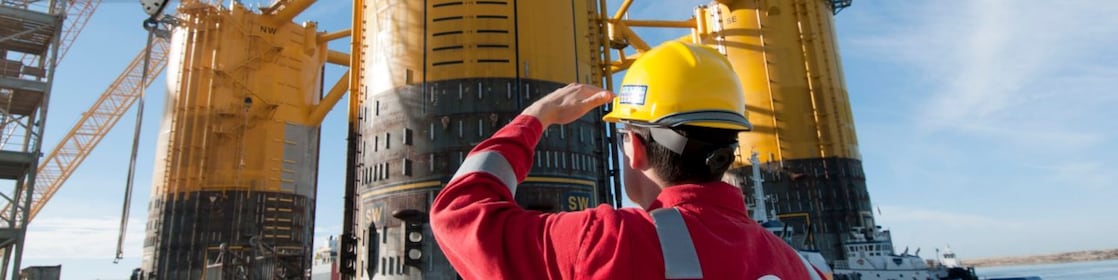 Engineer looking up at platform under construction