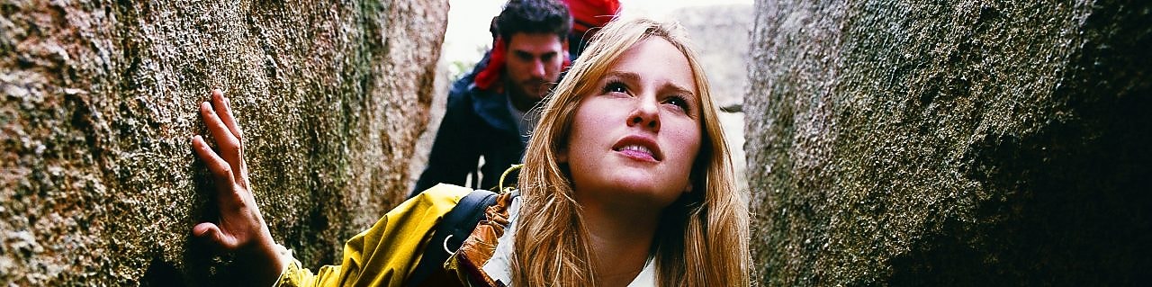 Two People Orienteering Between Rocks