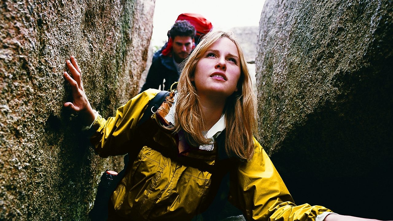 Two People Orienteering Between Rocks