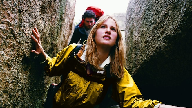 Two People Orienteering Between Rocks