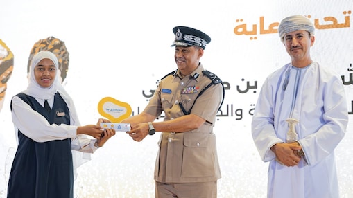 The photo with the cop handing over a trophy: Awarding participated schools