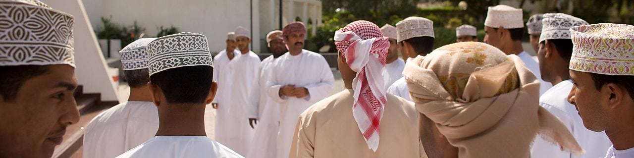 Omani locals gathering infront of building