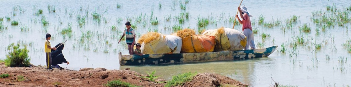 Local people cross the flooded Hawizeh Marshes, near the Majnoon project in Iraq