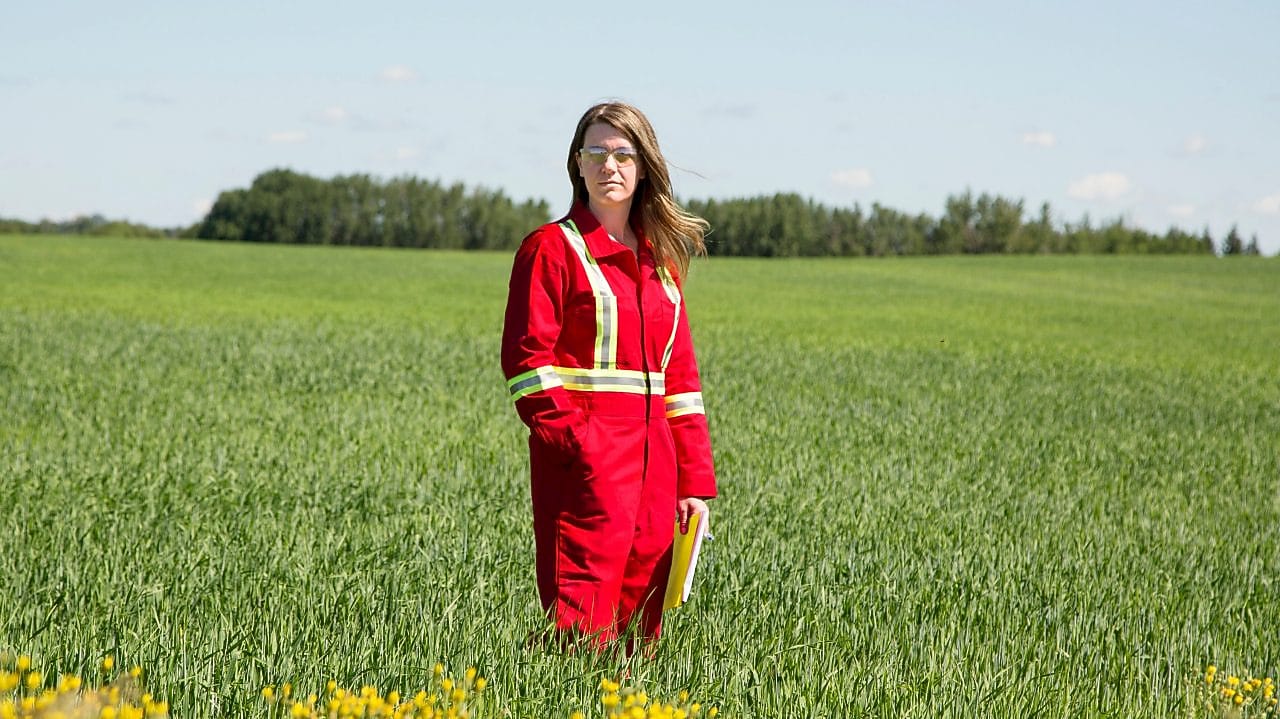 An employee stands in a field near a Quest C02 injection well northeast of Edmonton, Alberta in Canada