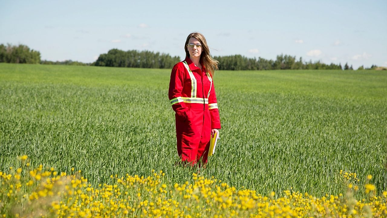 An employee stands in a field near a Quest C02 injection well northeast of Edmonton, Alberta in Canada
