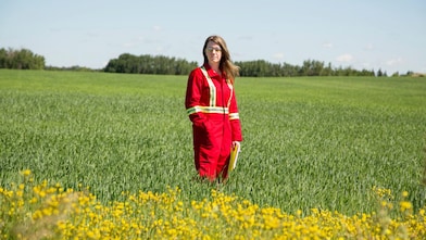 An employee stands in a field near a Quest C02 injection well northeast of Edmonton, Alberta in Canada