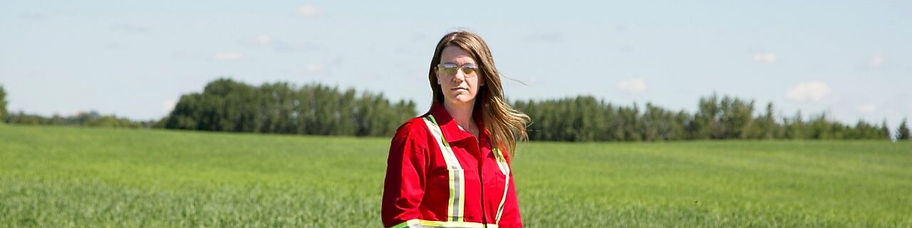 An employee stands in a field near a Quest C02 injection well northeast of Edmonton, Alberta in Canada